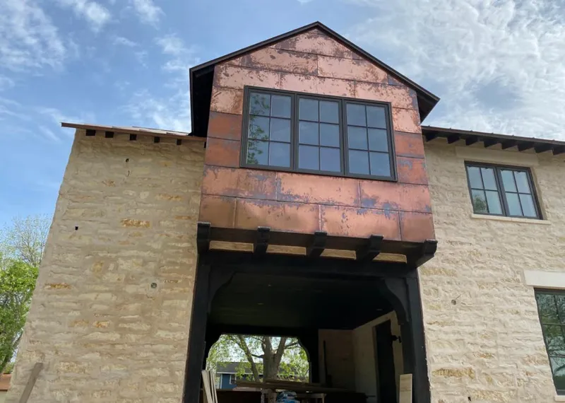 Copper metal panel facade on a stone building for Roof Repair in Salton City